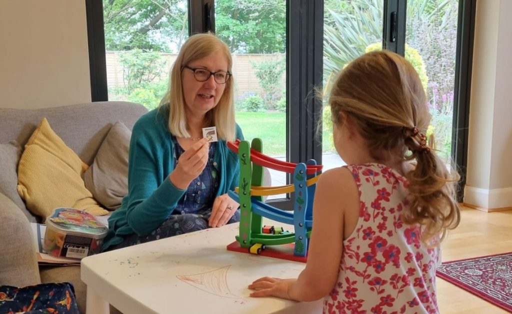 Anna Koppenhout speech and language therapist with a child during a therapy session.