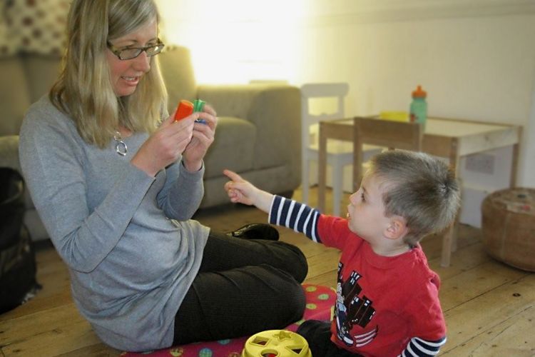 Using toys to encourage interaction in a speech and language therapy session.